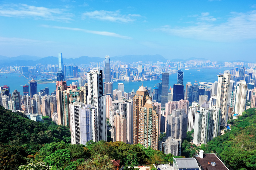 Urban architecture in Hong Kong Victoria Harbor in the day with blue sky and cloud.