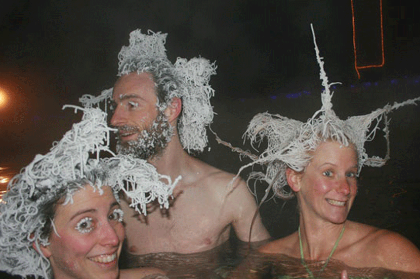 Un homme et deux femmes dans un bain chaud avec les cheveux geles au canada en plein hiver